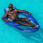 Adult man relaxing on a SwimWays Spring Float Recliner XL in a pool, enjoying leisure time, SKU 6069706, Wholesale Pool Mart WPM.